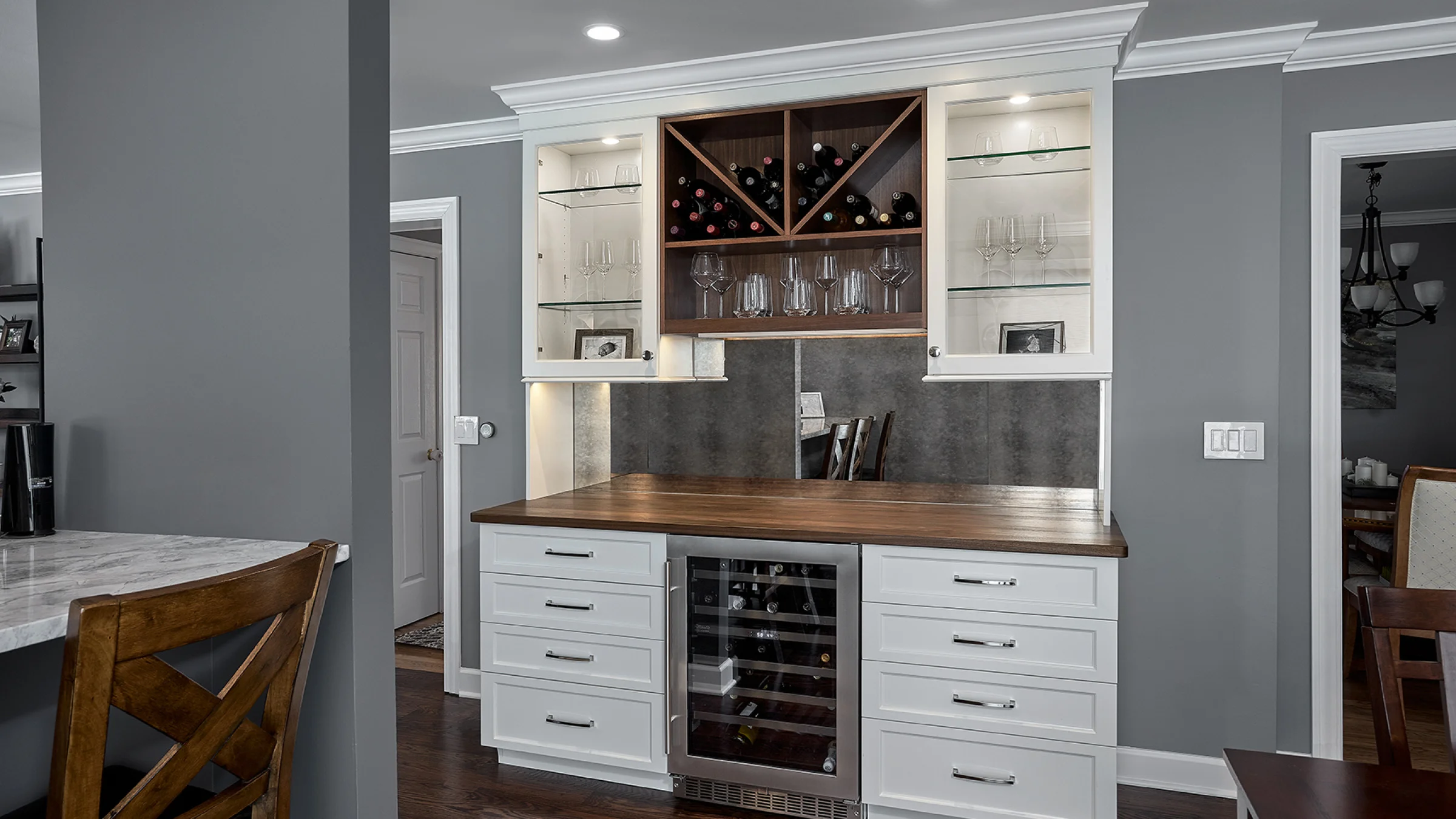 Palatine kitchen remodel: Custom white cabinets, wood countertop, built-in wine fridge, and wine rack display.