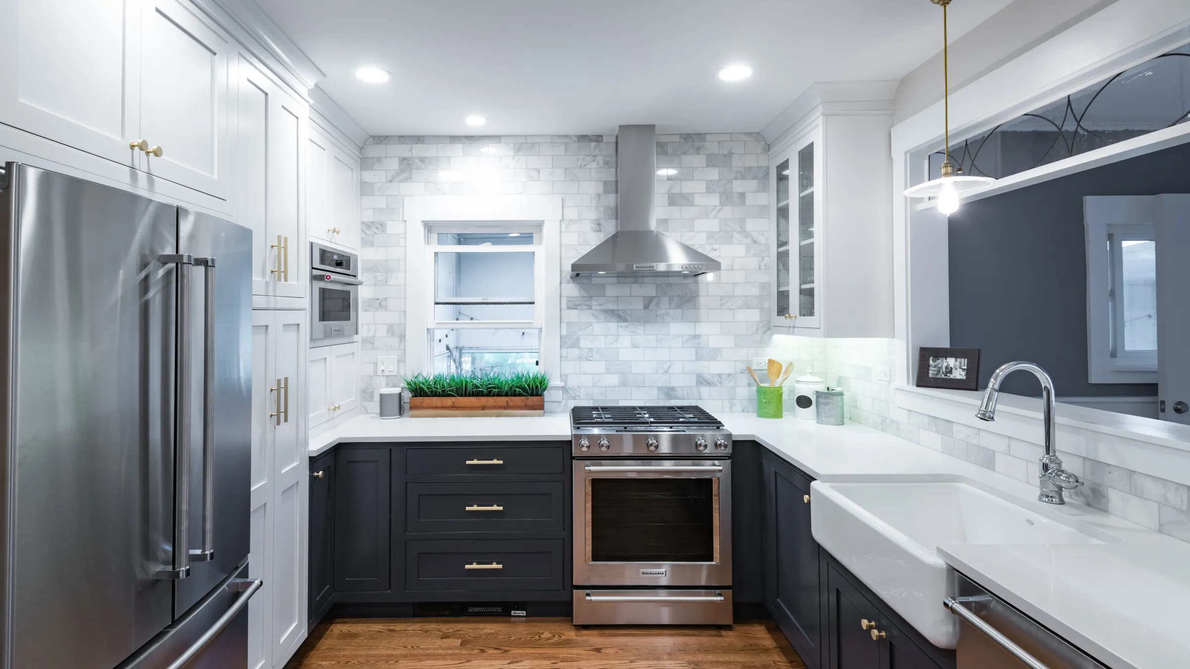 Palatine kitchen remodel: gray cabinets, white marble backsplash, stainless steel appliances, farmhouse sink, and wood floors