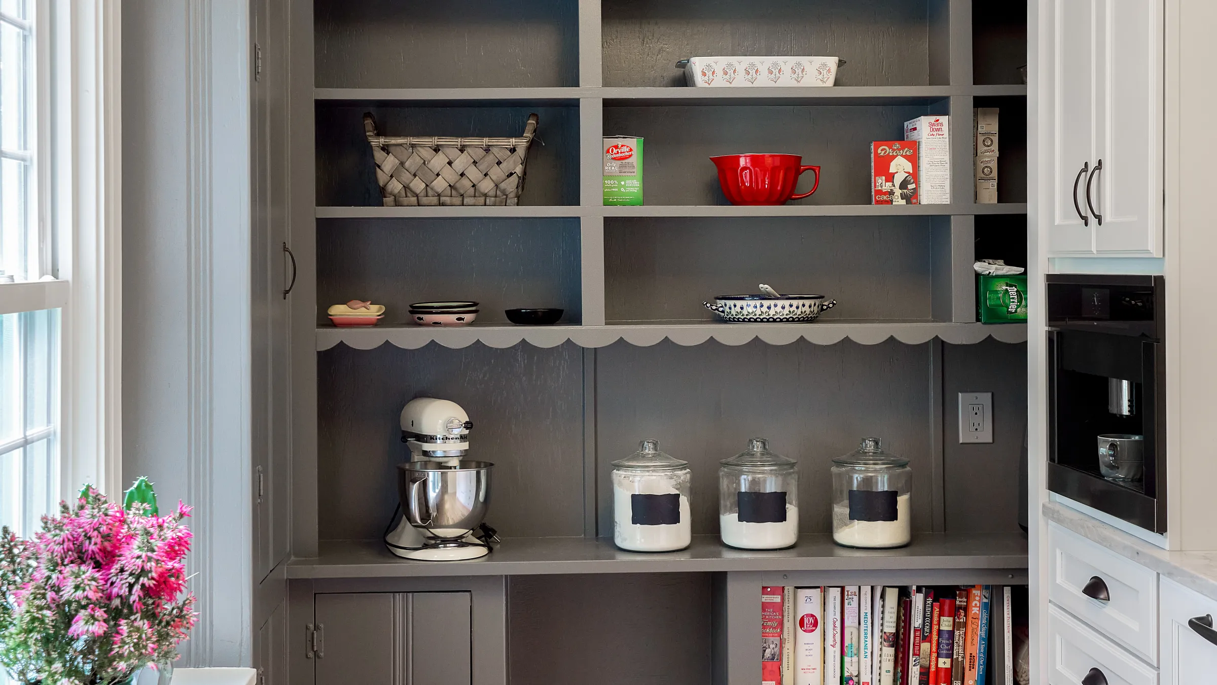 Custom gray kitchen pantry with open shelving, mixer, cookbooks, and glass jars. Kitchen remodel in Arlington Heights, IL.
