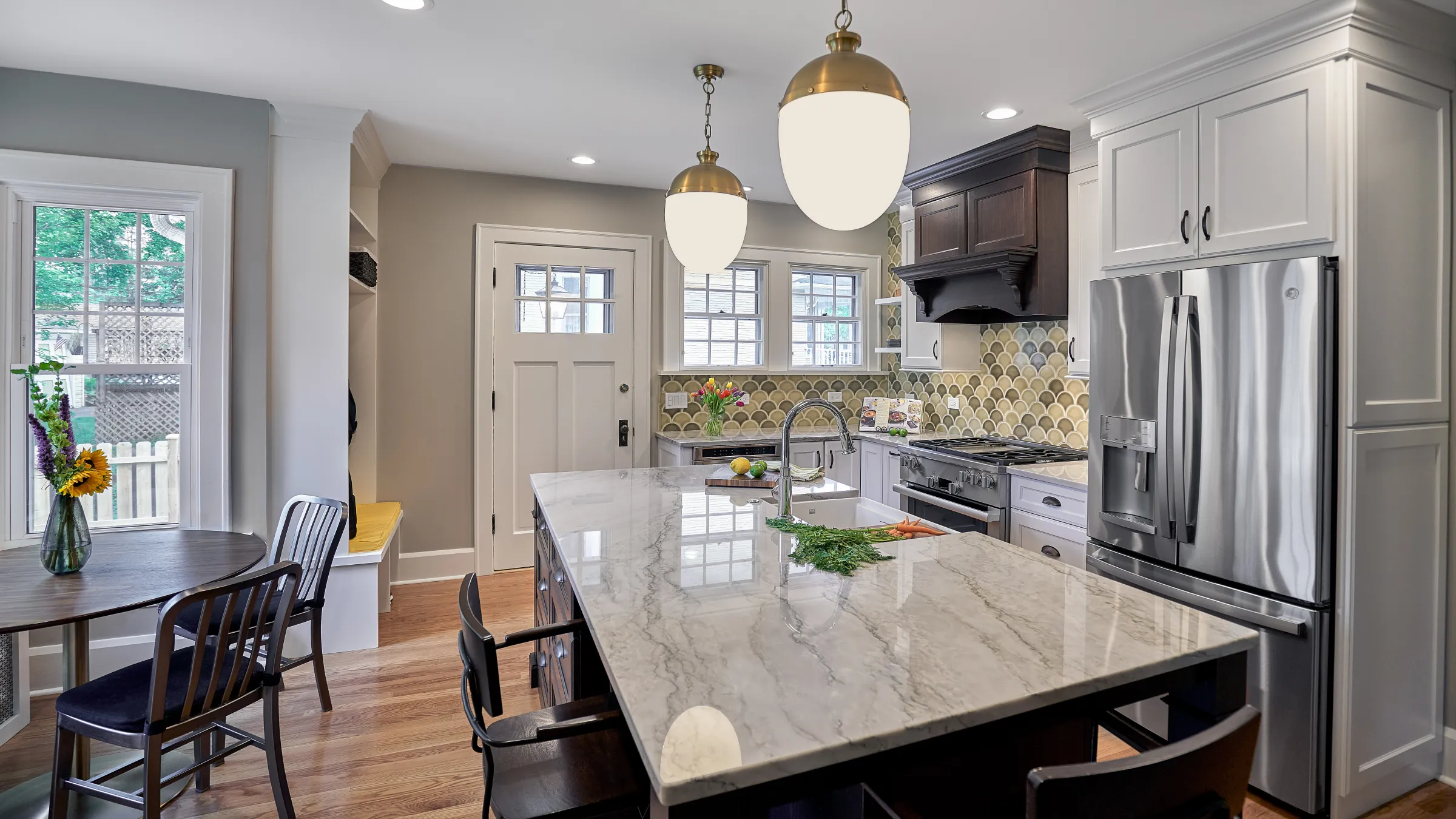 Arlington Heights kitchen remodel: Marble island, stainless steel appliances, custom cabinets, and wood floors.