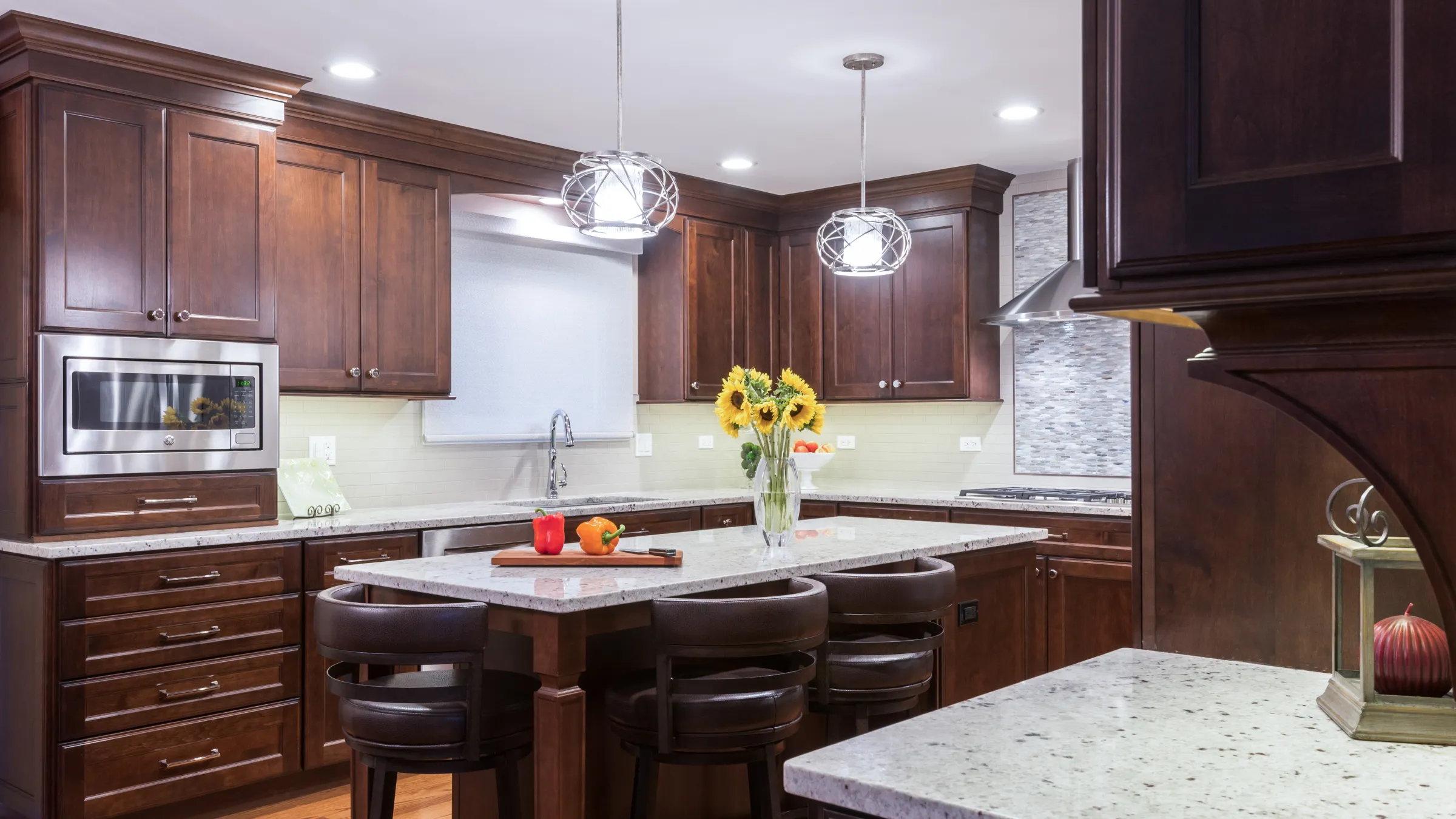 Palatine kitchen remodel with dark wood cabinets, granite countertops, stainless steel appliances, and modern lighting.