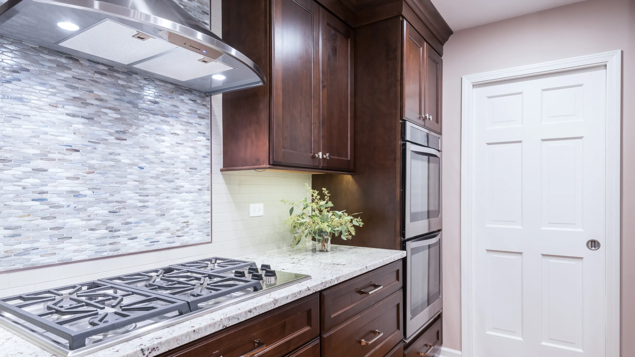 Palatine kitchen remodel featuring dark wood cabinets, granite countertops, stainless steel appliances, and mosaic backsplash