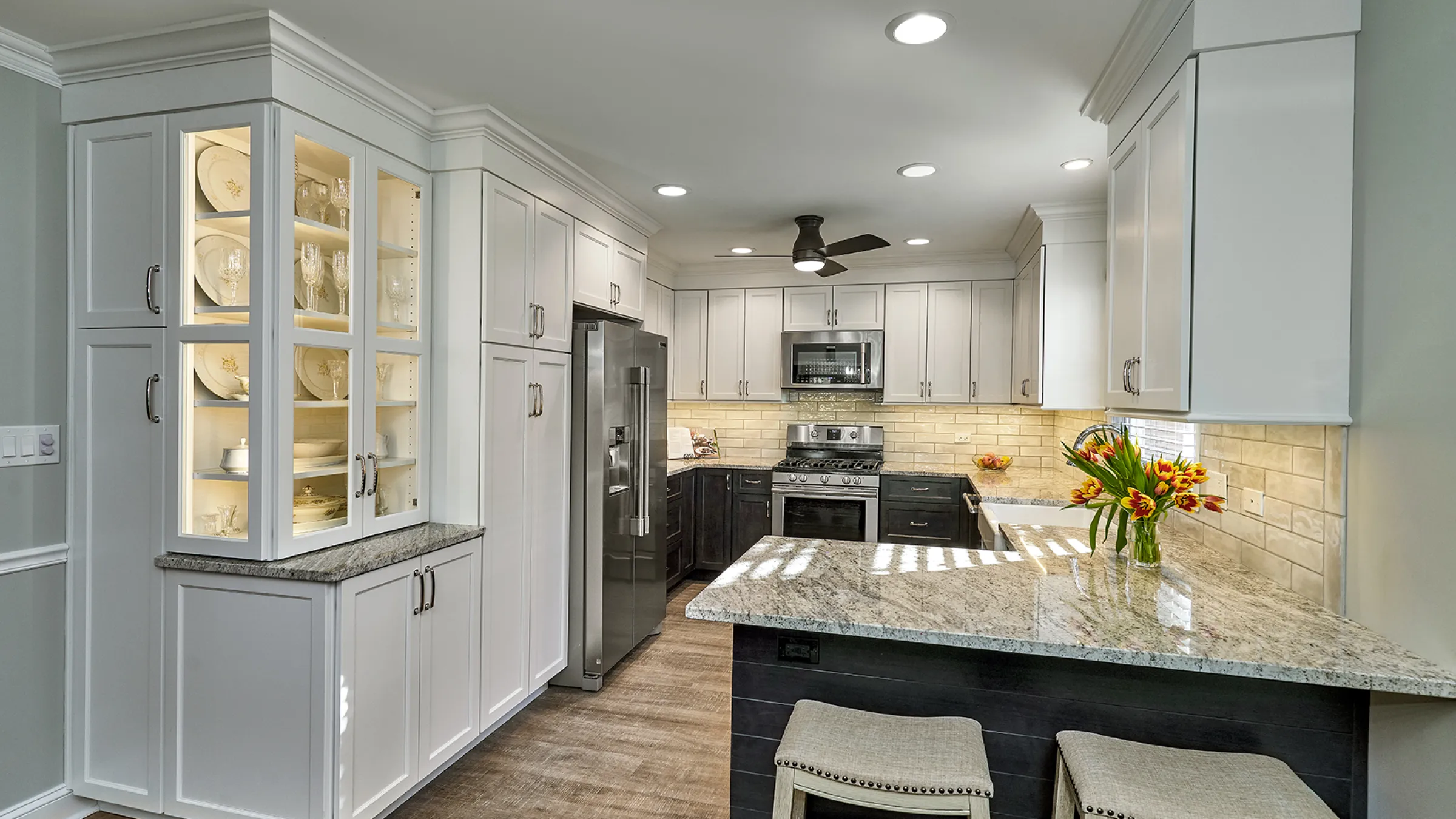 Lake Zurich, IL kitchen remodel with white cabinets, granite countertops, stainless steel appliances, and wood floors.