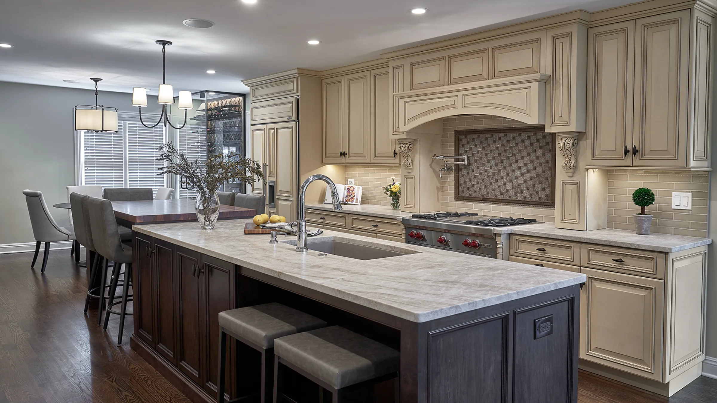 Inverness, IL kitchen remodel featuring custom cabinets, marble countertops, a kitchen island, and wood flooring.
