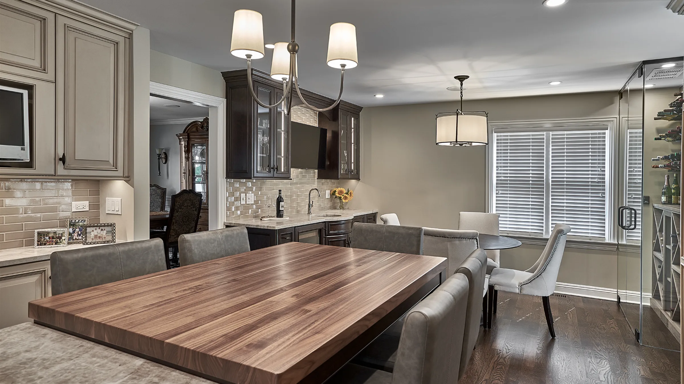 Inverness, IL kitchen remodel with custom cabinets, wood island, wine fridge, and modern lighting.