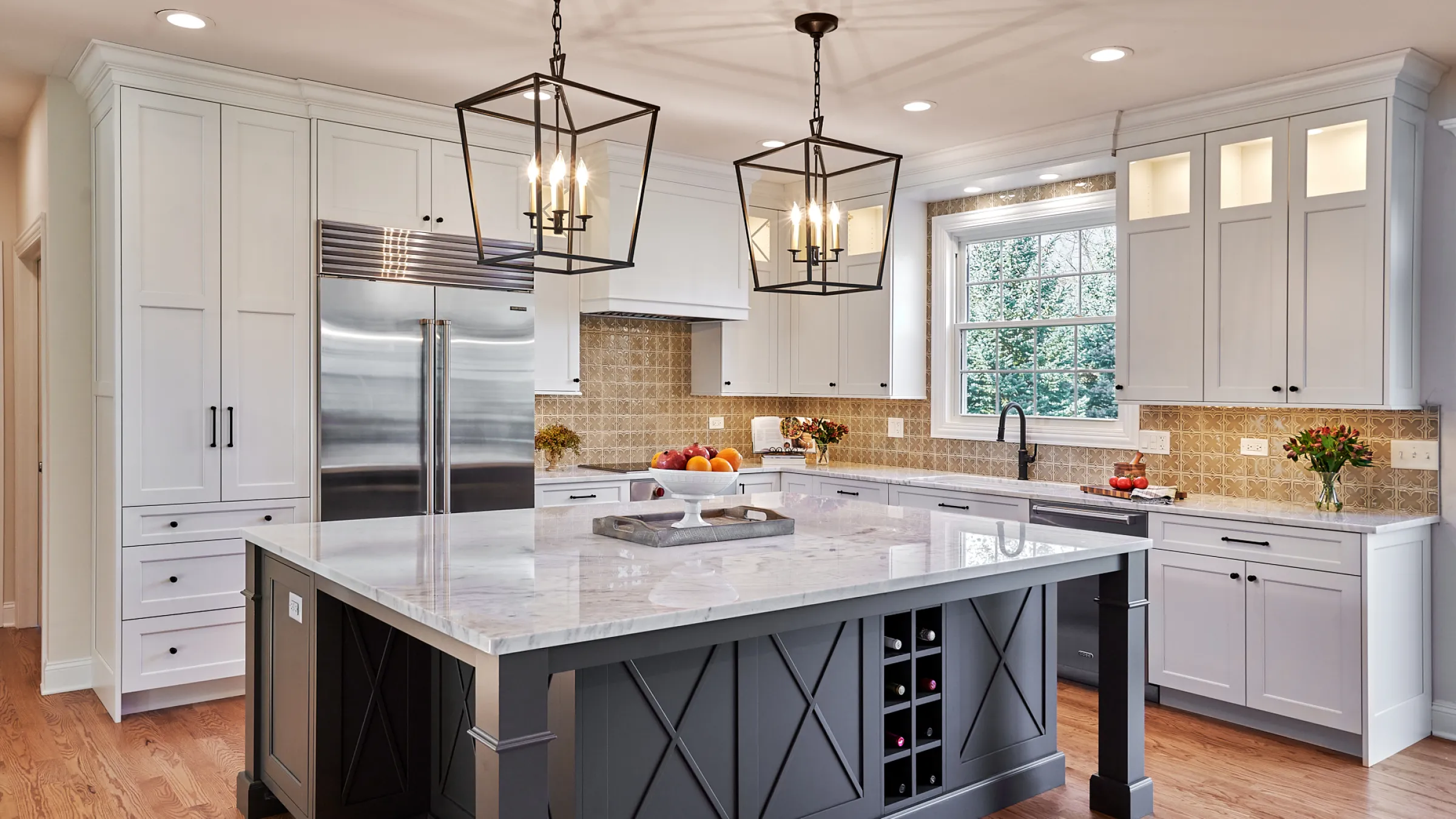 Barrington kitchen remodel featuring white cabinets, marble countertops, a gray island, and modern lighting.