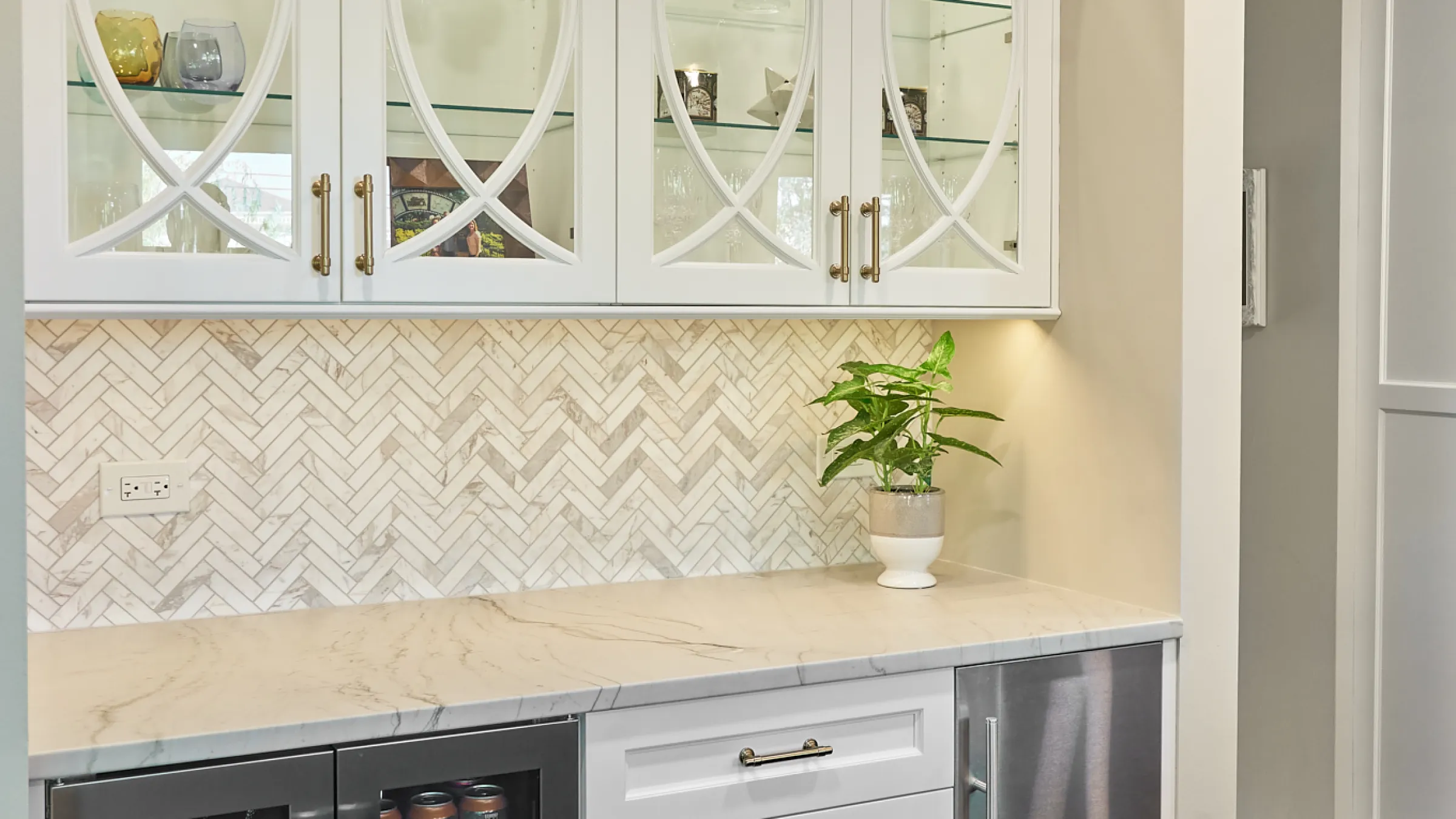 Palatine, IL kitchen remodel with white cabinets, herringbone backsplash, quartz countertops, and beverage fridge.