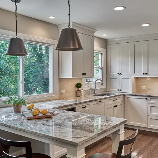Bright kitchen remodel in Hoffman Estates featuring white cabinets, granite countertops, and stainless steel fixtures.