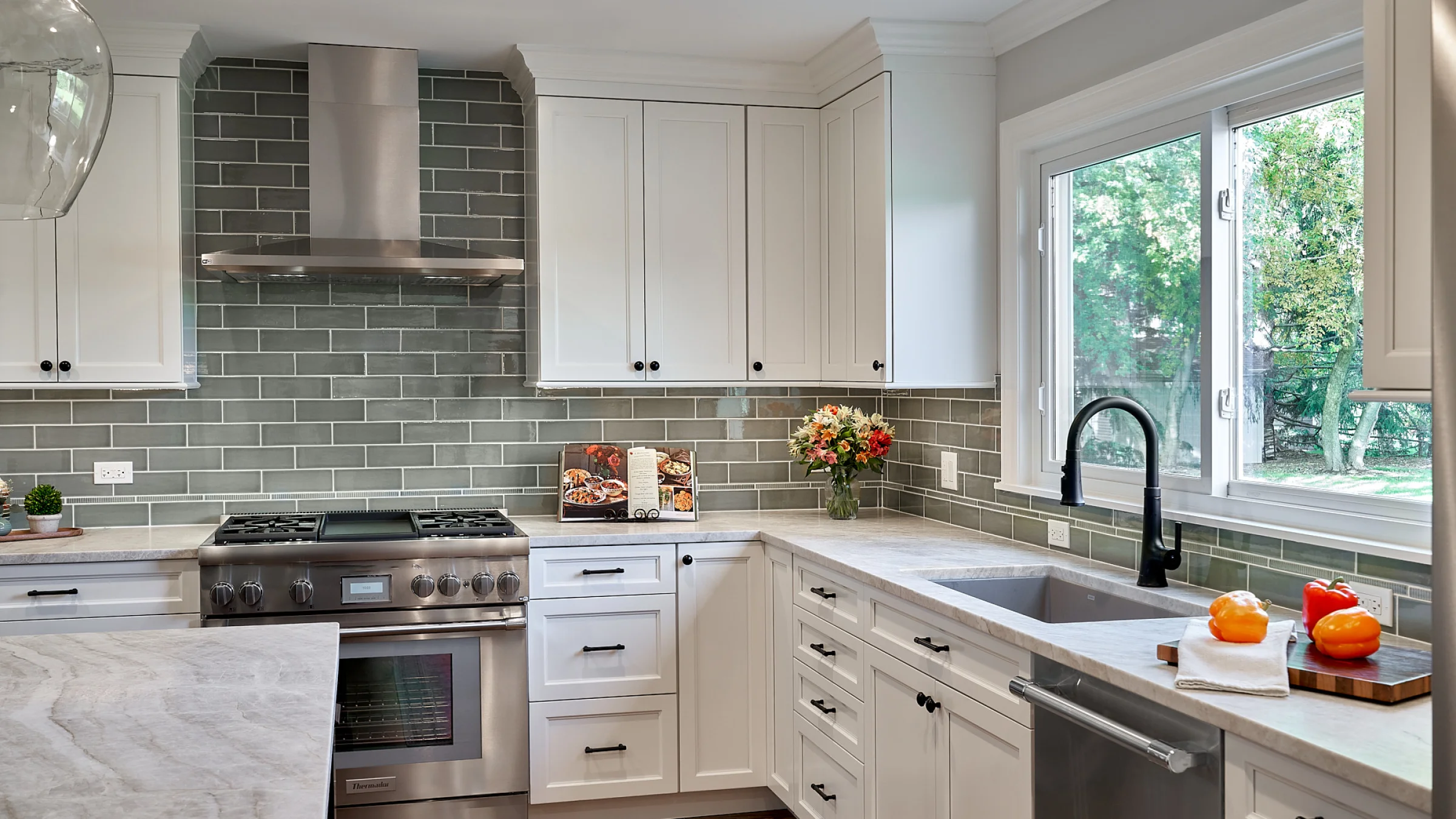 Inverness kitchen remodel with white shaker cabinets, gray subway tile backsplash, and stainless steel appliances.