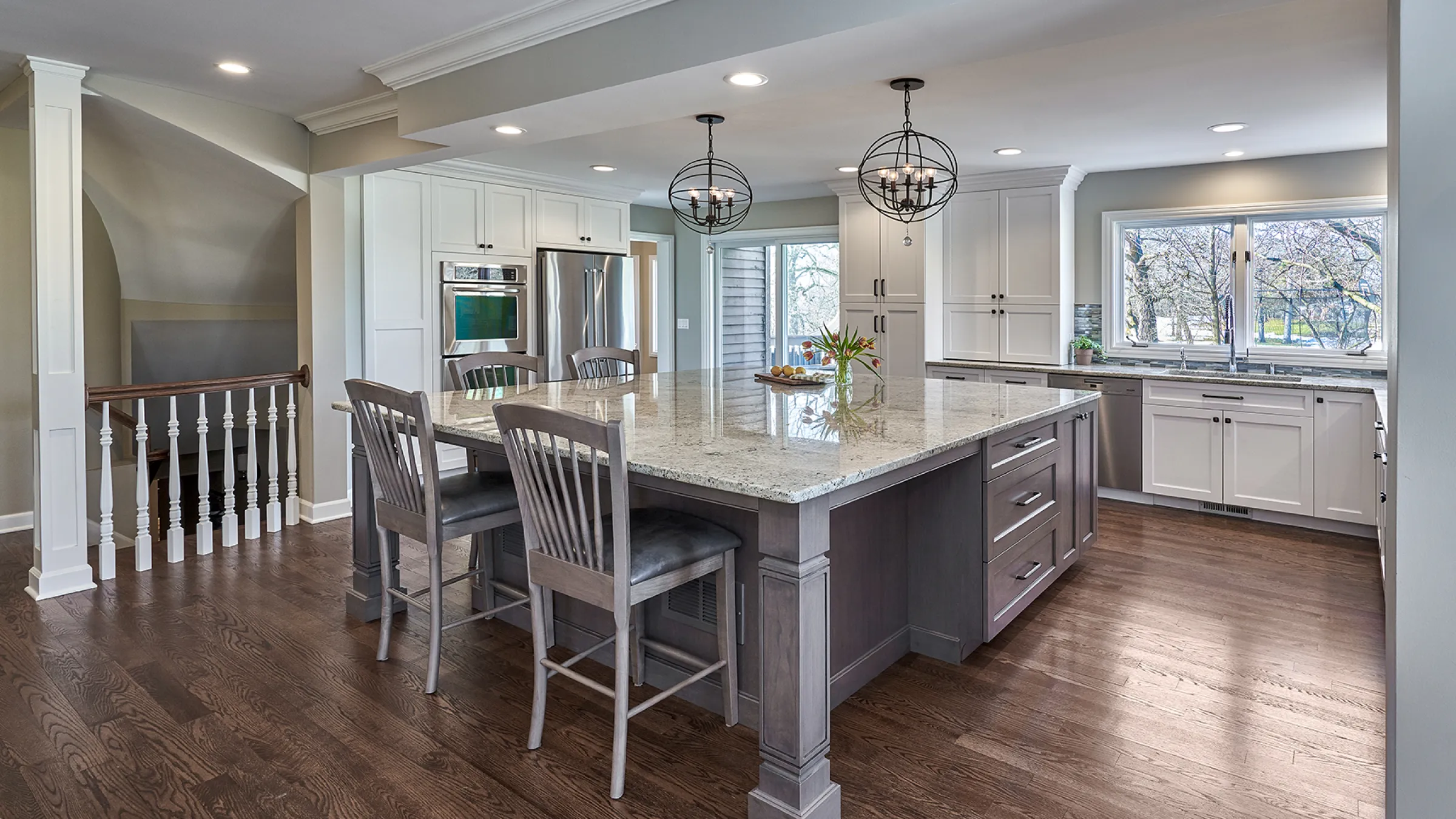 Long Grove, IL kitchen remodel featuring a large island, white cabinets, granite countertops, and hardwood floors.