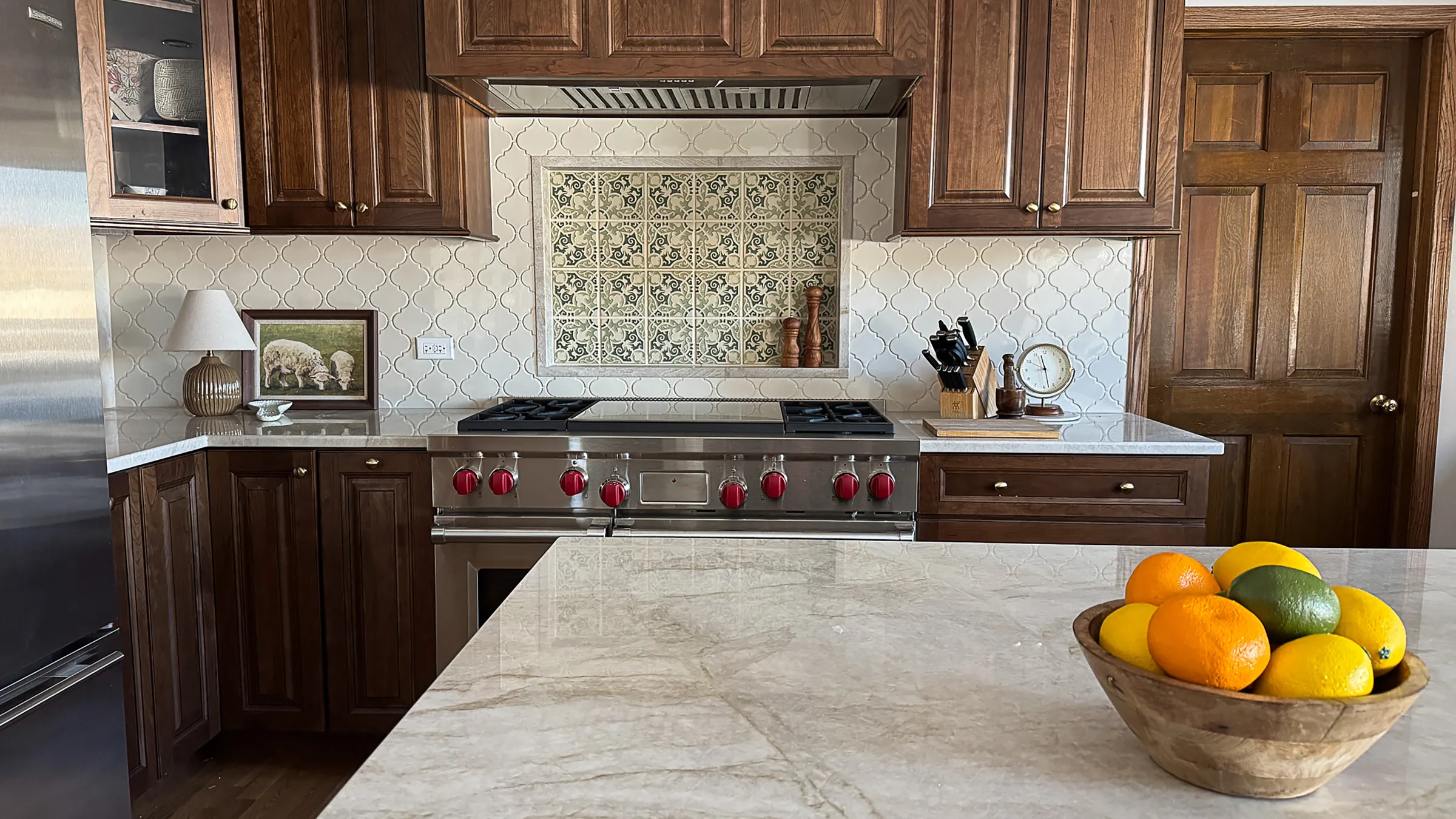 Arlington Heights kitchen remodel with wood cabinets, tile backsplash, stainless steel range, and marble countertops.