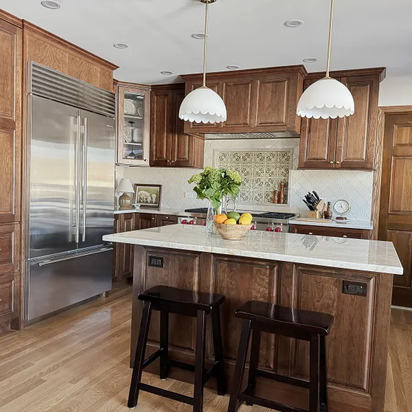 Arlington Heights kitchen remodel with wood cabinets, white quartz countertops, stainless steel appliances, and pendant light