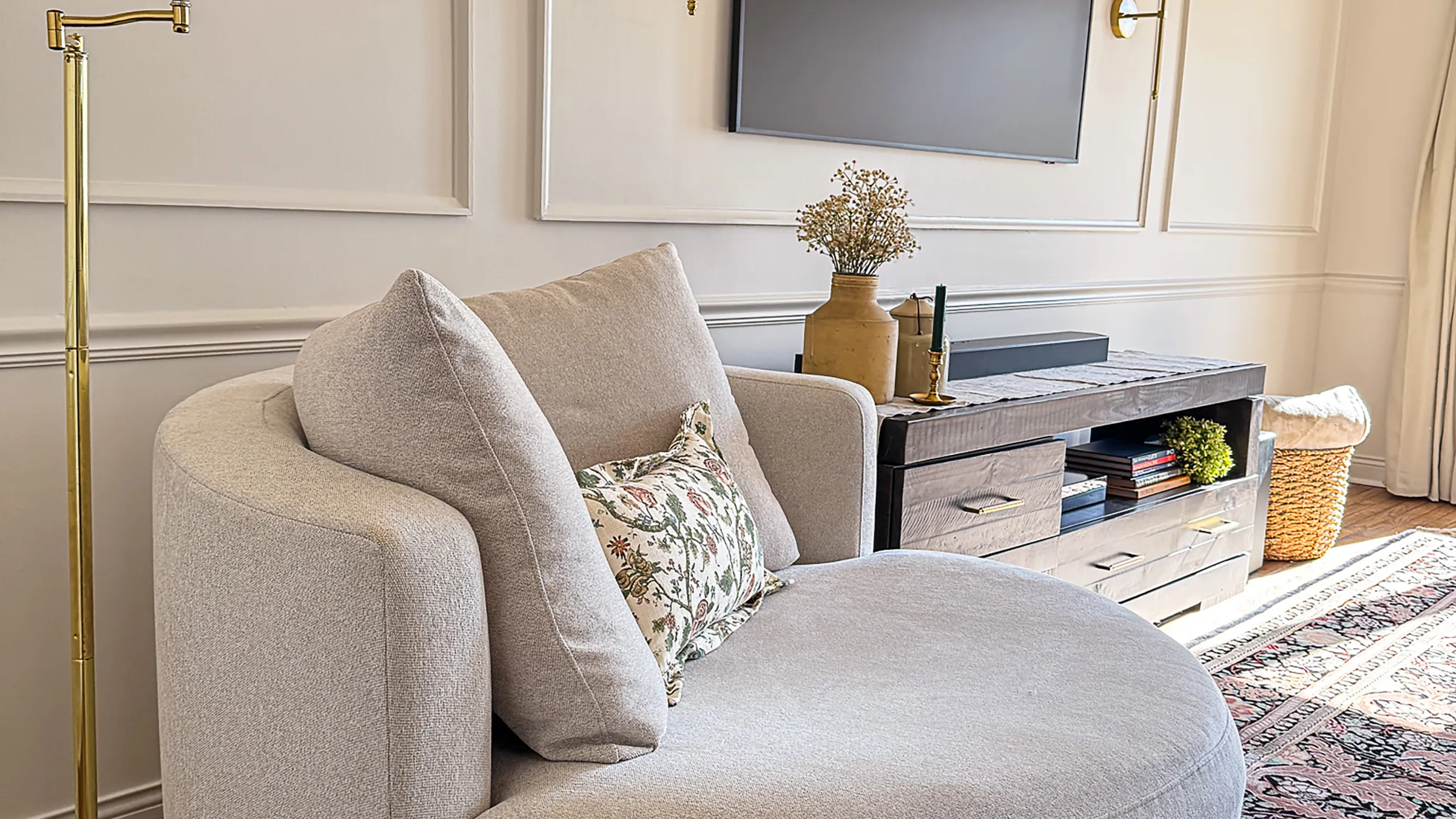 Arlington Heights living room with chaise lounge, custom media console, and elegant wall trim.