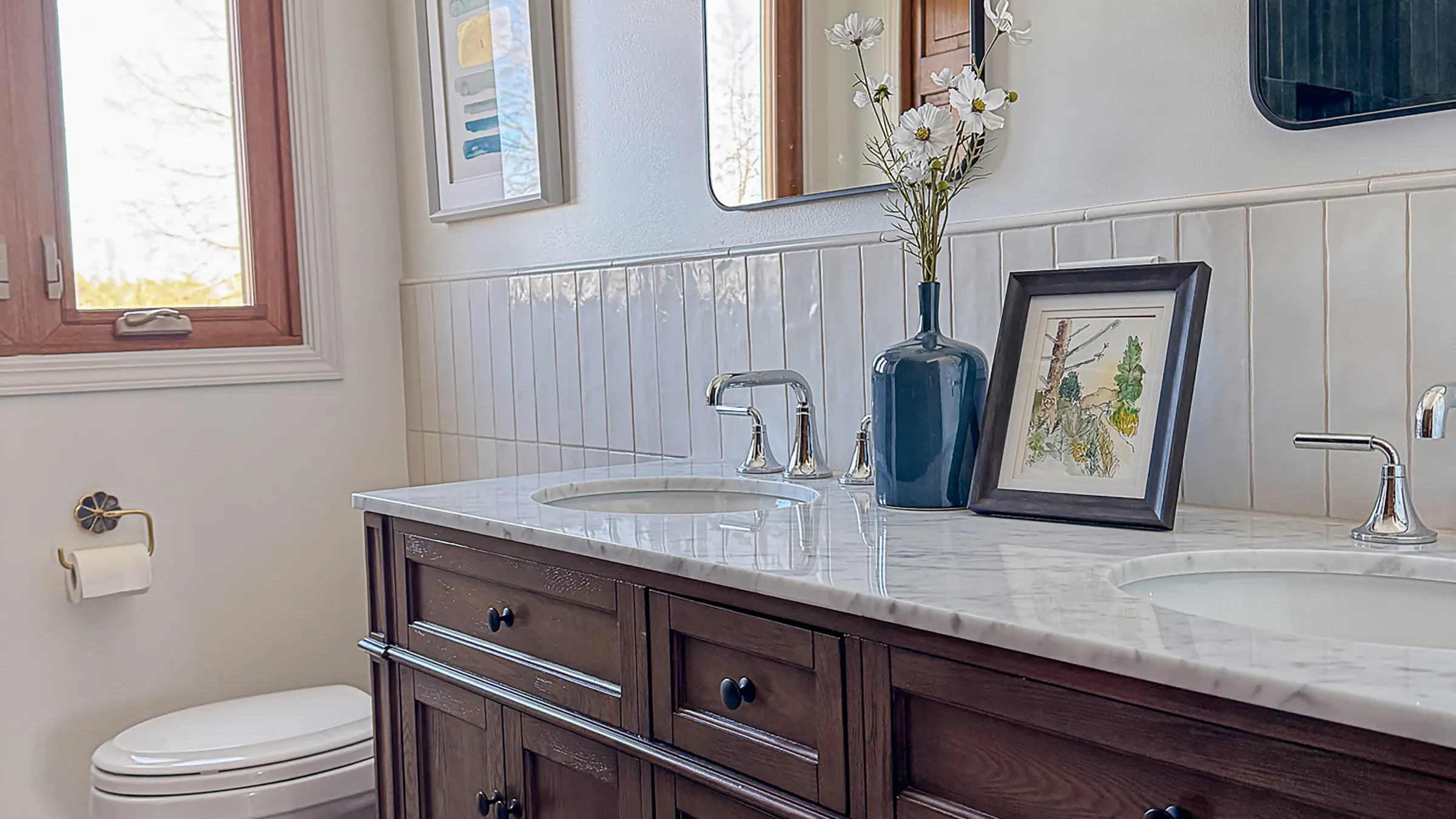 Bathroom remodel featuring marble countertop, wood vanity, white tile, and modern fixtures in Arlington Heights.