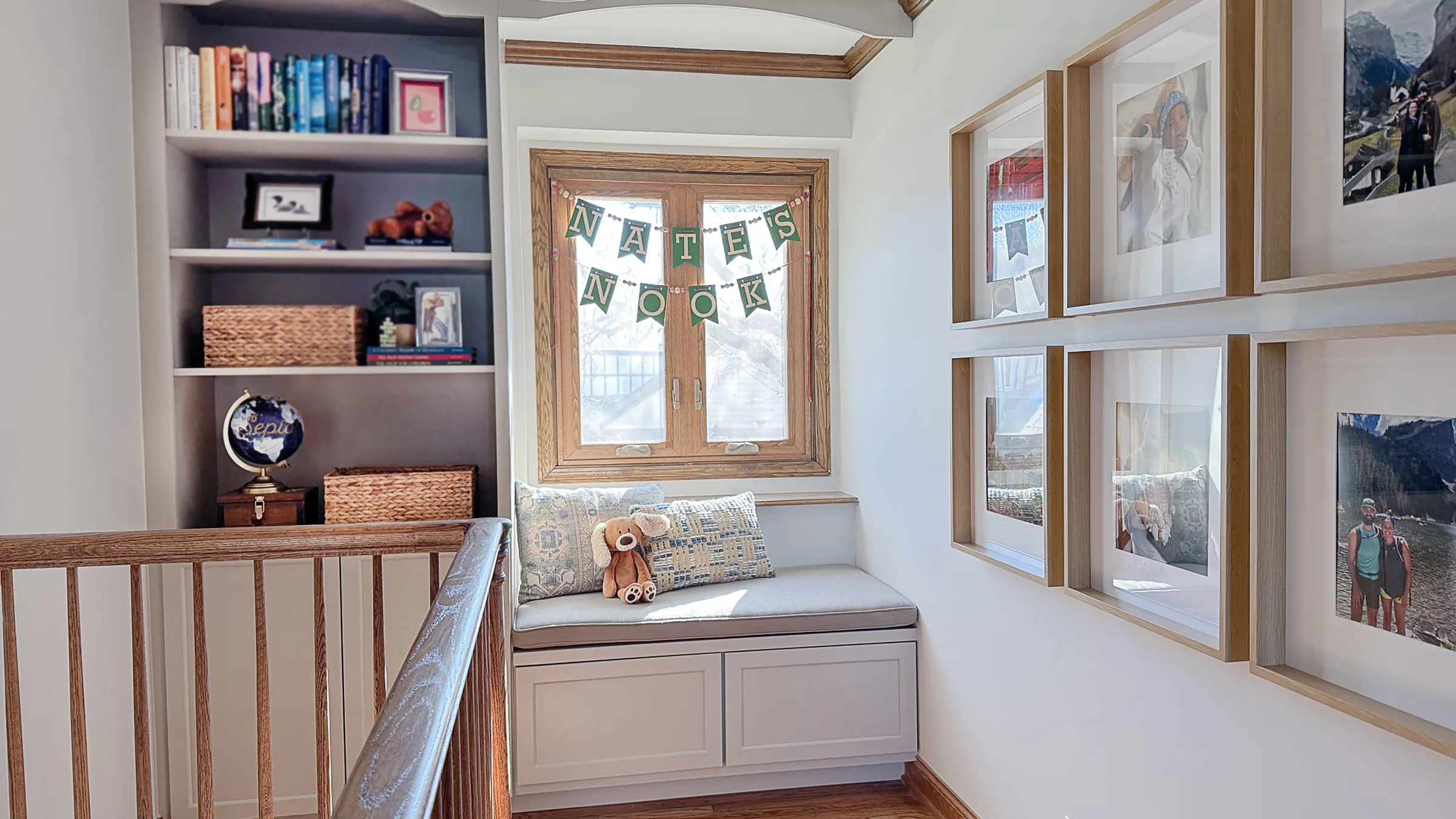 Arlington Heights home nook with custom window seat, built-in shelving, and framed family photos on the wall.