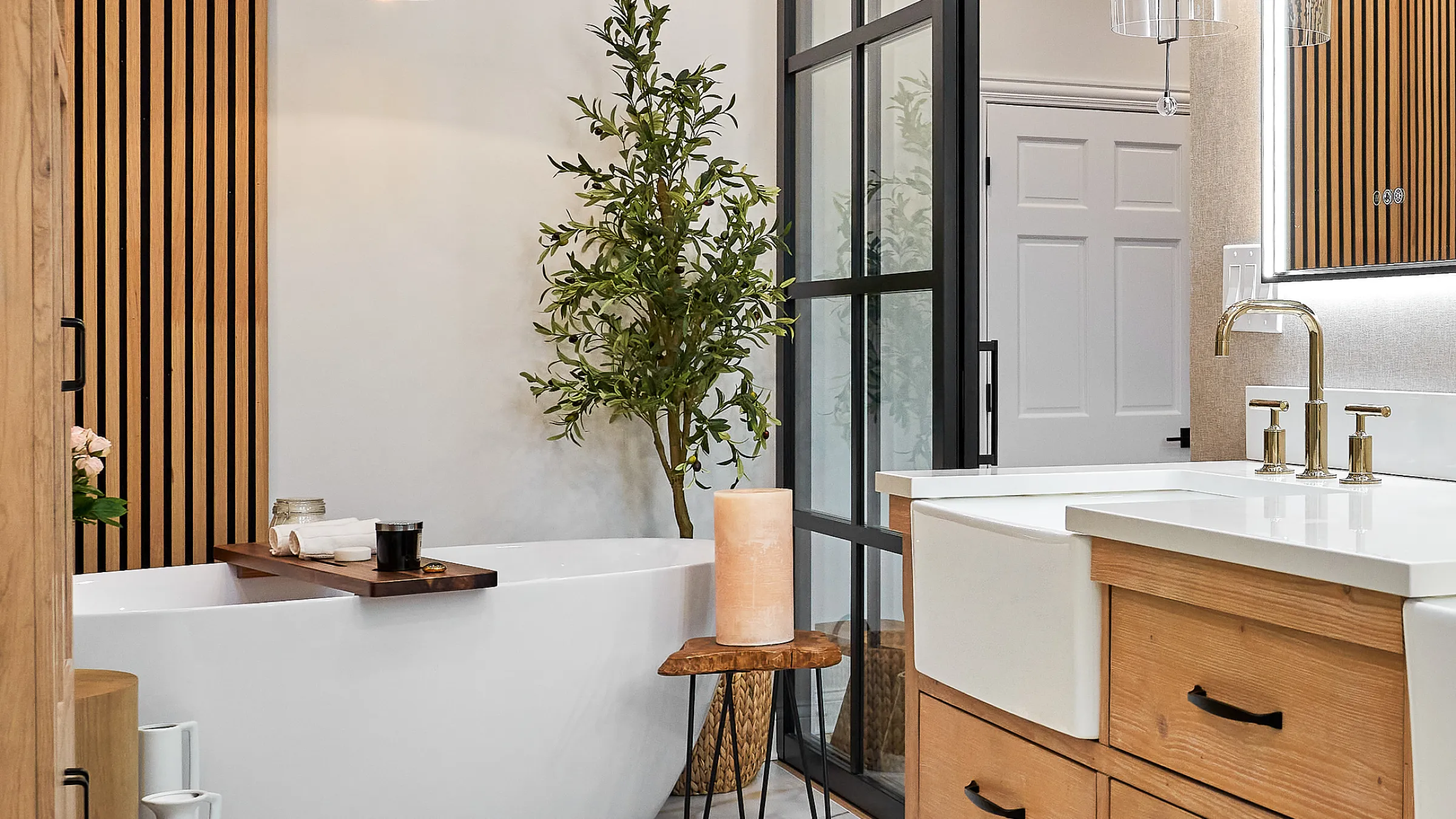 Prospect Heights bathroom remodel with freestanding tub, wood vanity, gold fixtures, and modern black framed shower.