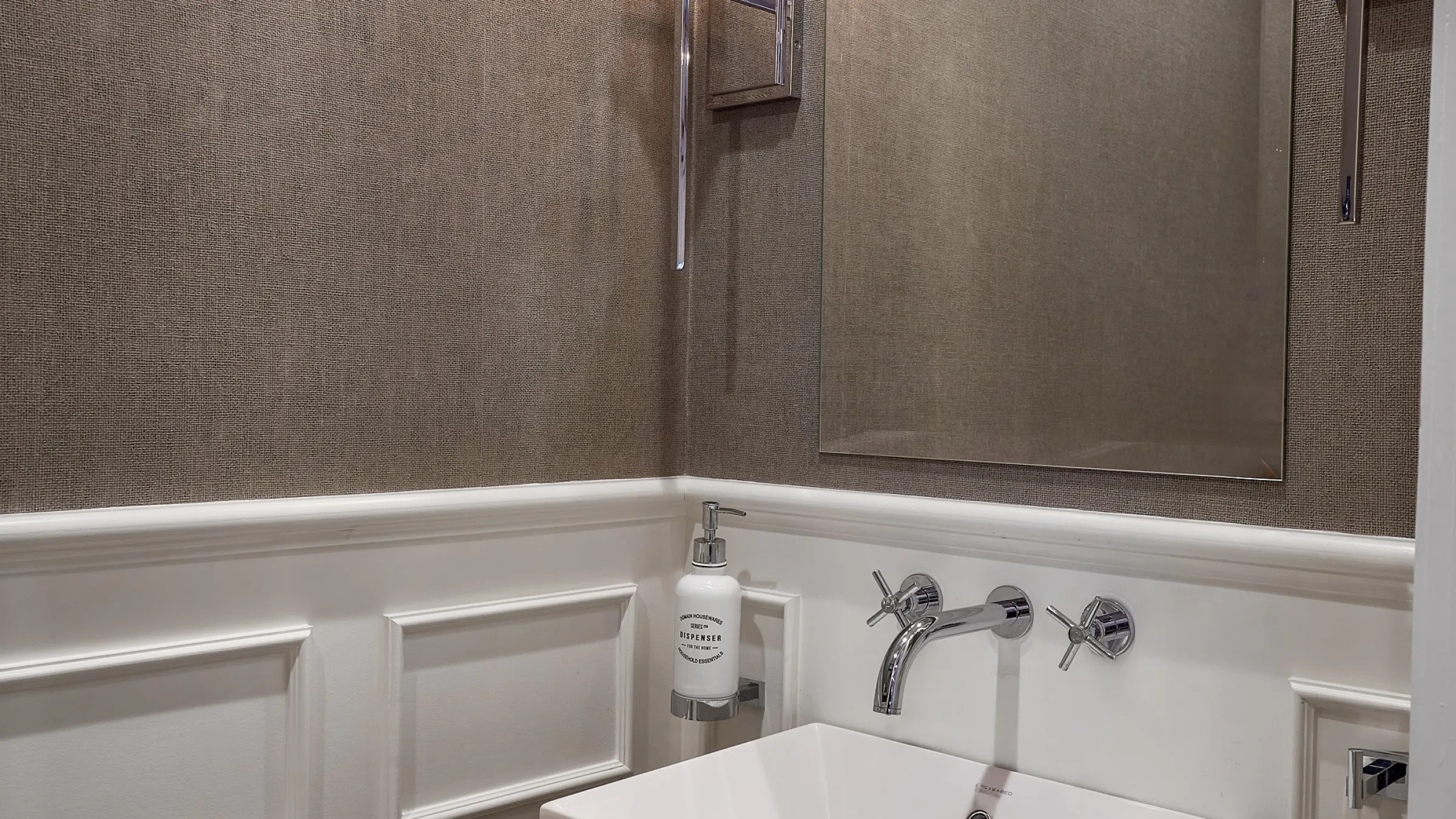 Bathroom remodel: White vanity with chrome faucet, soap dispenser, textured wall in Prospect Heights, IL.