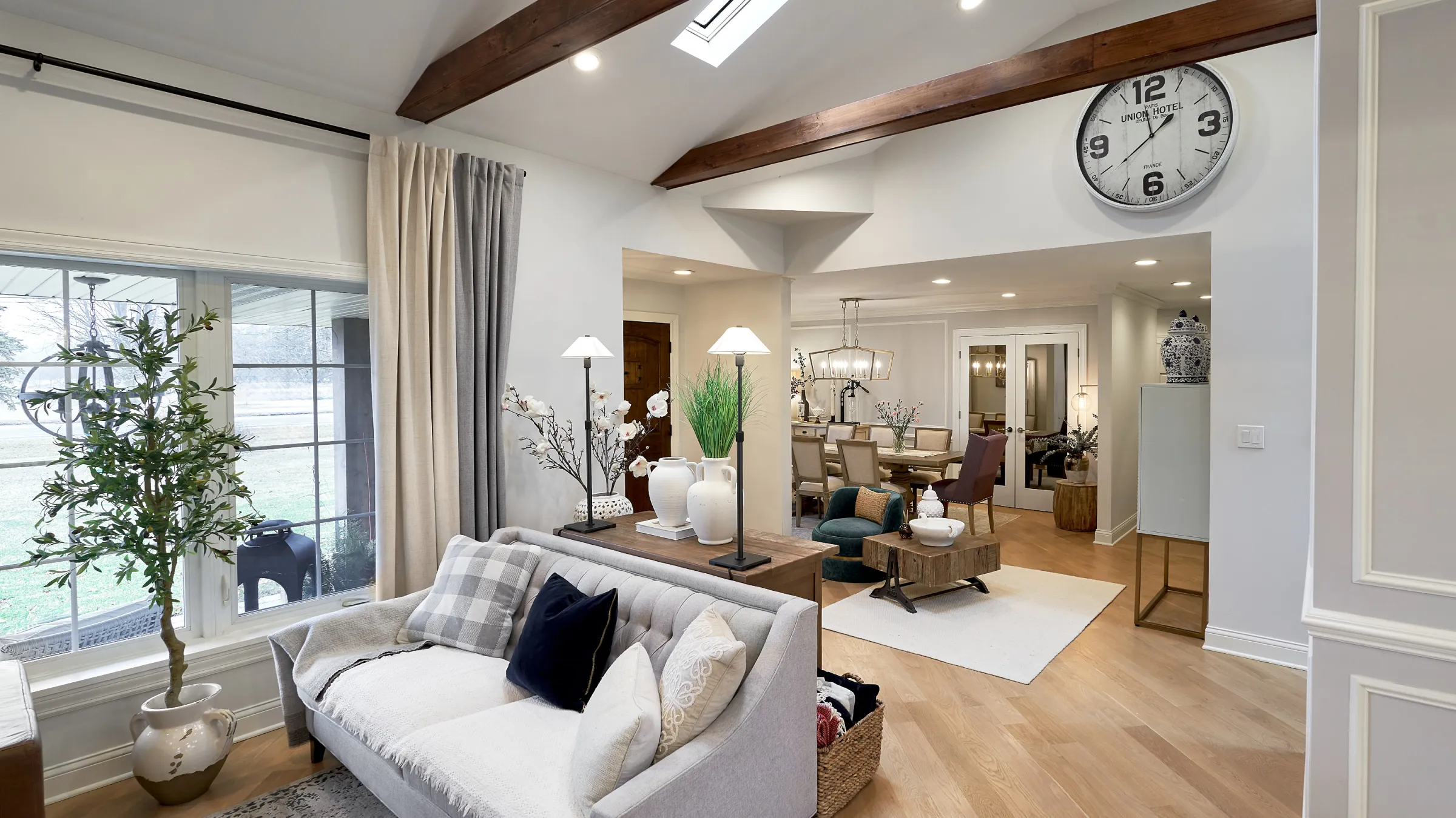 Prospect Heights living room remodel with wood beams, herringbone flooring, and elegant decor.