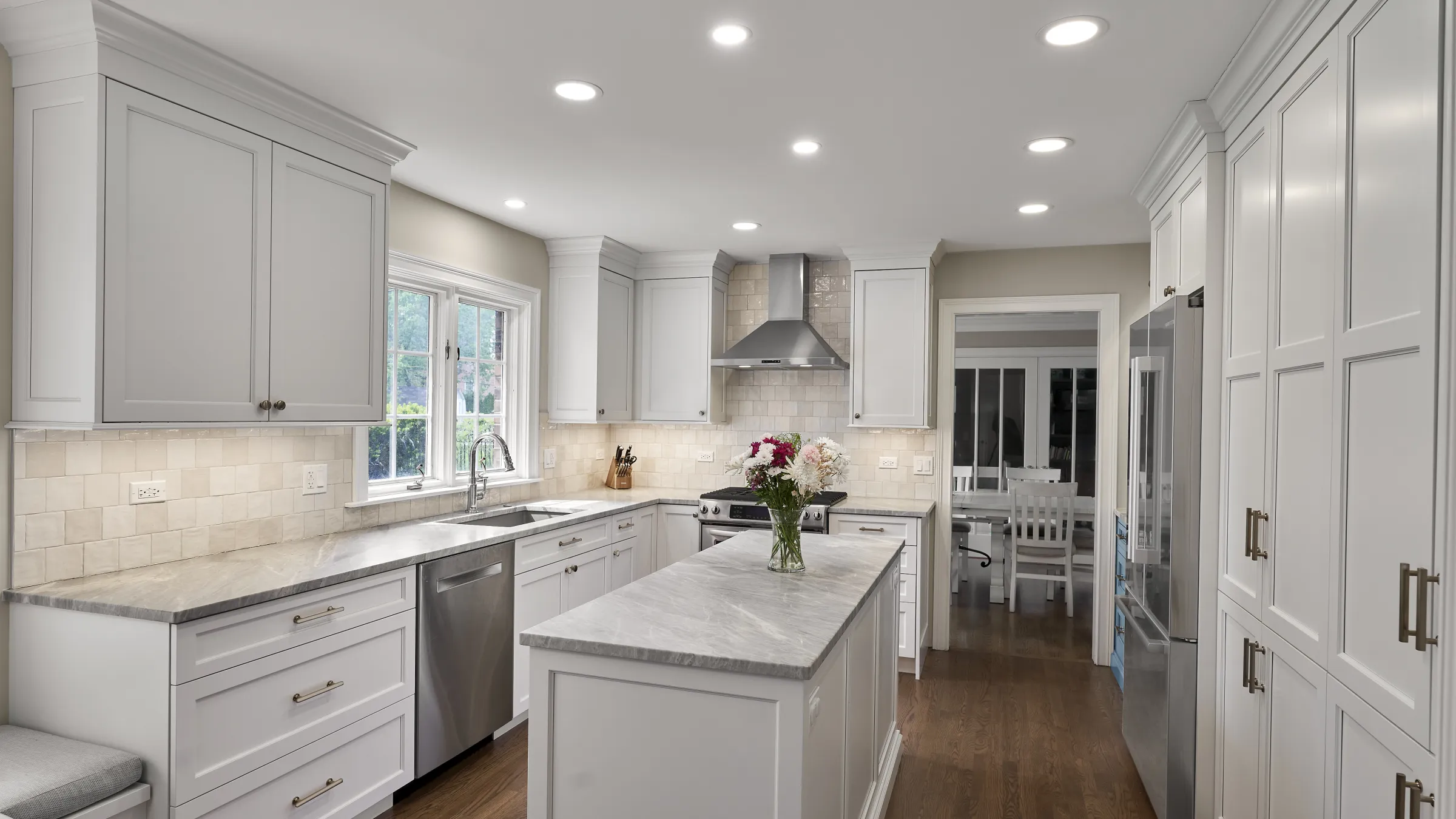 Bright Arlington Heights kitchen remodel with white shaker cabinets, gray marble countertops, stainless steel appliances, and