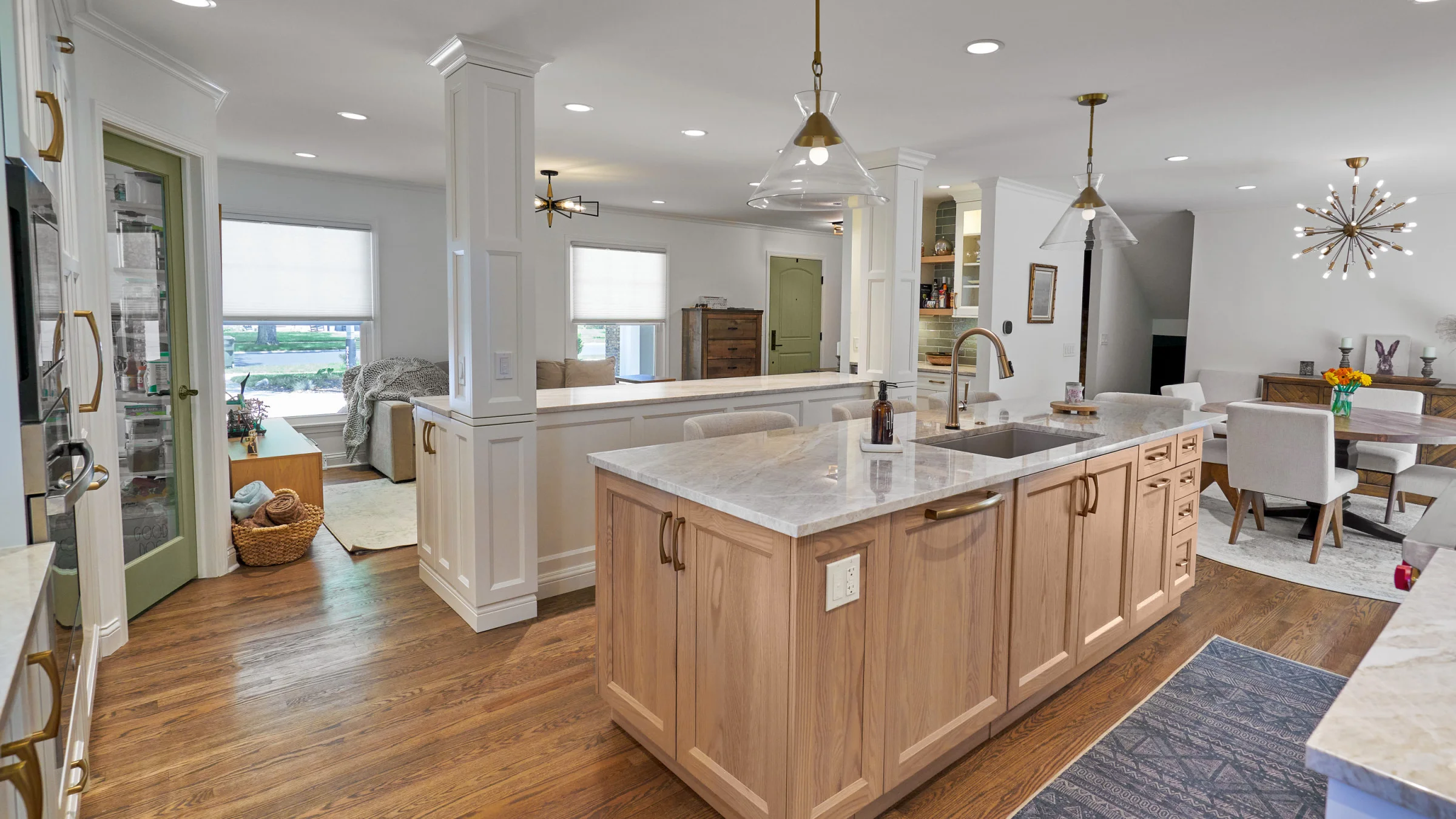 Arlington Heights kitchen remodel: wood cabinets, marble countertops, open concept design, hardwood floors, stylish lighting.