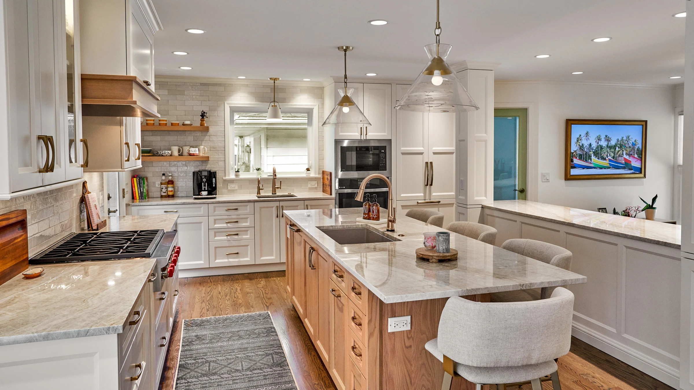 Arlington Heights kitchen remodel: island with marble countertop, wood cabinets, hardwood floors, and modern pendant lights.