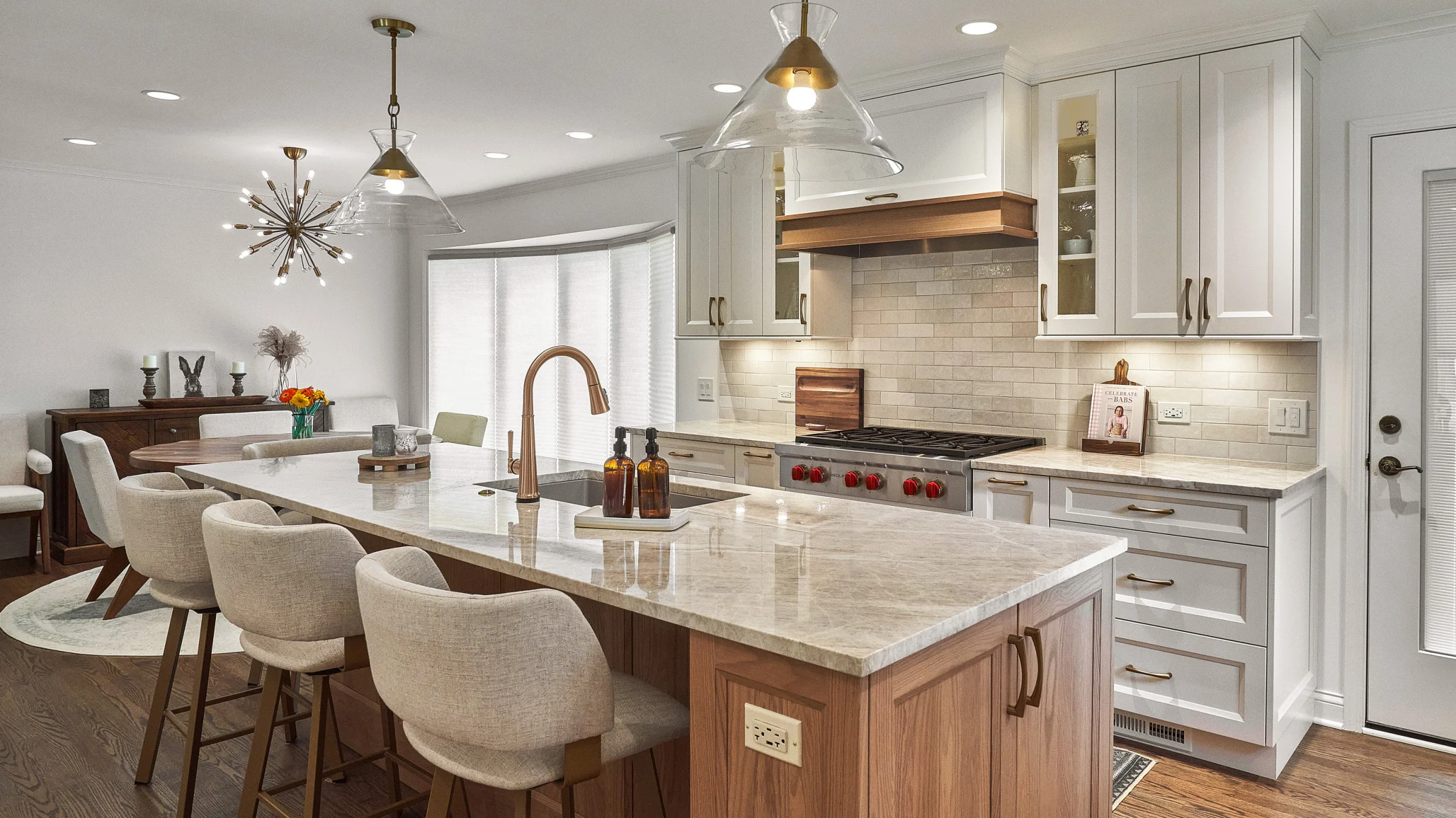 Arlington Heights kitchen remodel with island, marble countertops, wood cabinets, and bronze fixtures by GS Construction.