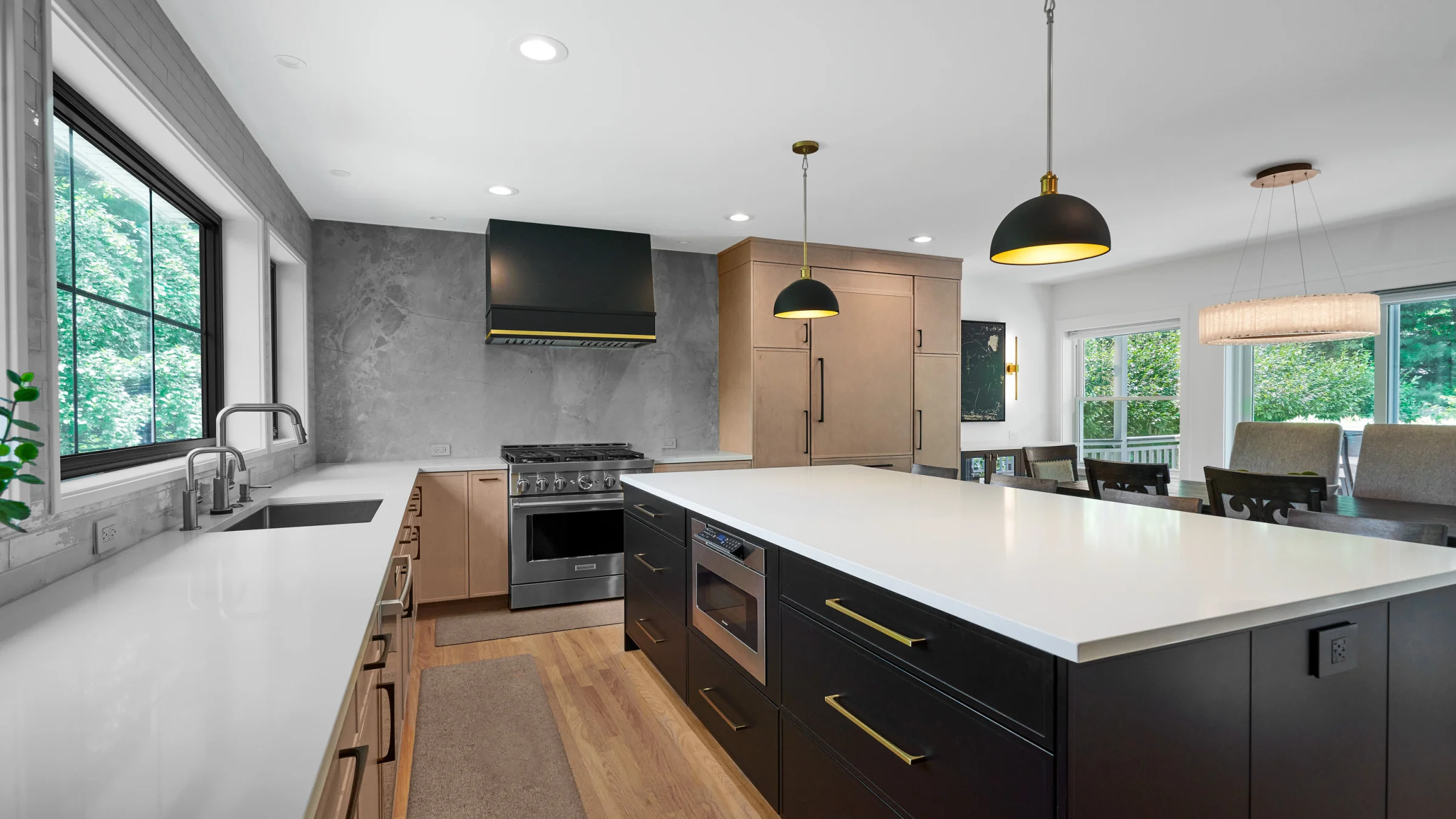 Modern Palatine kitchen remodel with black island, white countertops, custom cabinets, and stainless steel appliances.