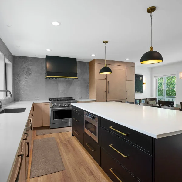 Modern Palatine kitchen remodel with black island, white countertops, custom cabinets, and stainless steel appliances.