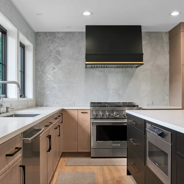 Modern kitchen remodel in Palatine, IL: quartz countertops, stainless steel appliances, custom cabinets, black range hood.