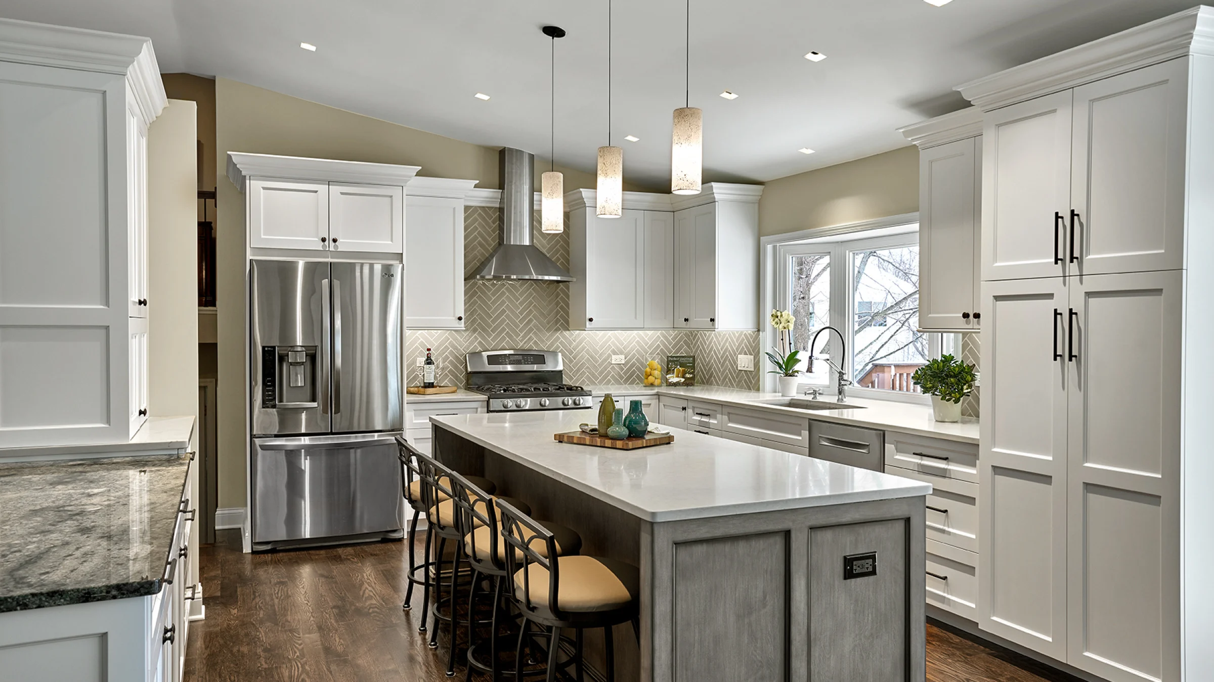 Hoffman Estates kitchen remodel with white cabinets, island seating, stainless steel appliances, and dark wood floors.
