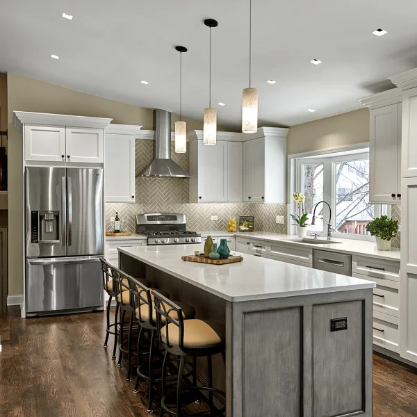 Hoffman Estates kitchen remodel with white cabinets, island seating, stainless steel appliances, and dark wood floors.